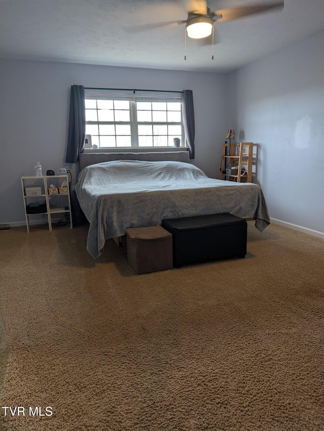 carpeted bedroom featuring ceiling fan and baseboards