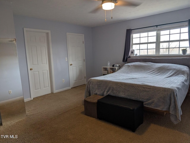 bedroom featuring ceiling fan, carpet, and baseboards