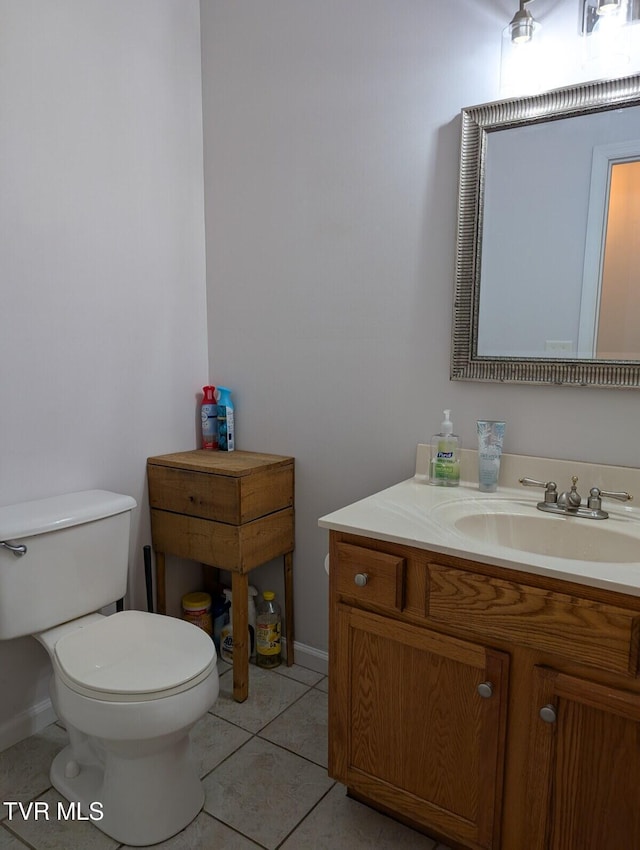 bathroom with vanity, tile patterned flooring, and toilet