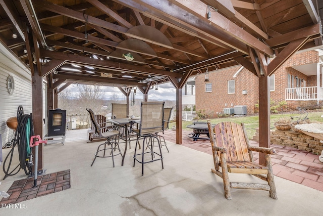 view of patio featuring outdoor dining space and central air condition unit