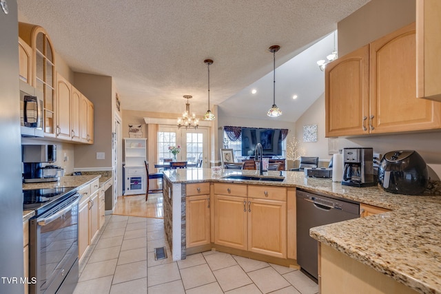 kitchen featuring dishwasher, stainless steel electric range oven, a peninsula, light brown cabinetry, and a sink