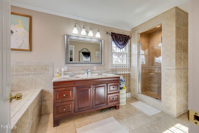 bathroom featuring double vanity, a stall shower, tile patterned flooring, and a sink