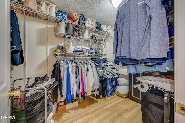 walk in closet featuring wood finished floors