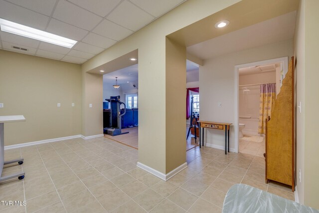 interior space with light tile patterned floors, a paneled ceiling, recessed lighting, visible vents, and baseboards