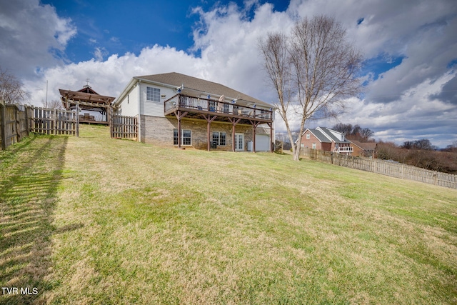 rear view of property with a fenced backyard, a deck, and a yard