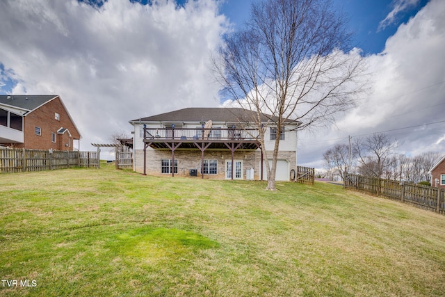 back of house with a yard, fence, and a wooden deck