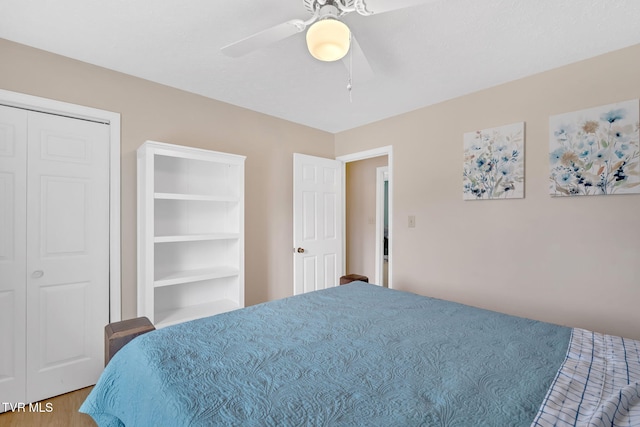 bedroom with a ceiling fan and wood finished floors