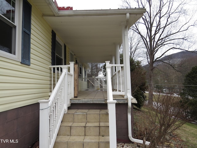 wooden terrace with a porch