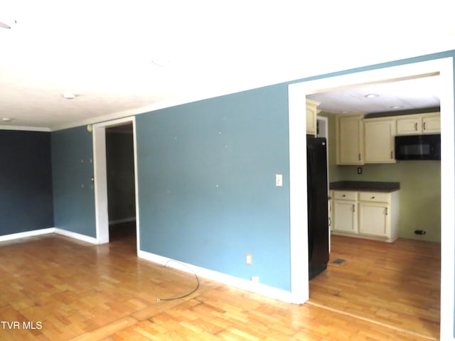 empty room with baseboards and light wood finished floors