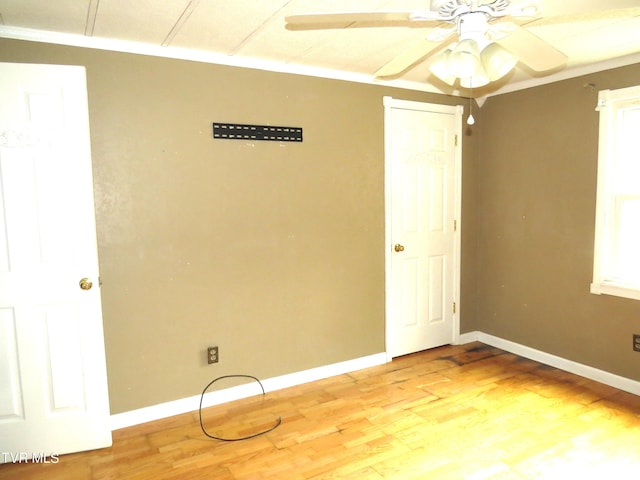 empty room with light wood-style floors, ceiling fan, and baseboards