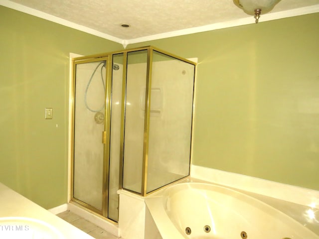 bathroom with a stall shower, a jetted tub, tile patterned flooring, and a textured ceiling