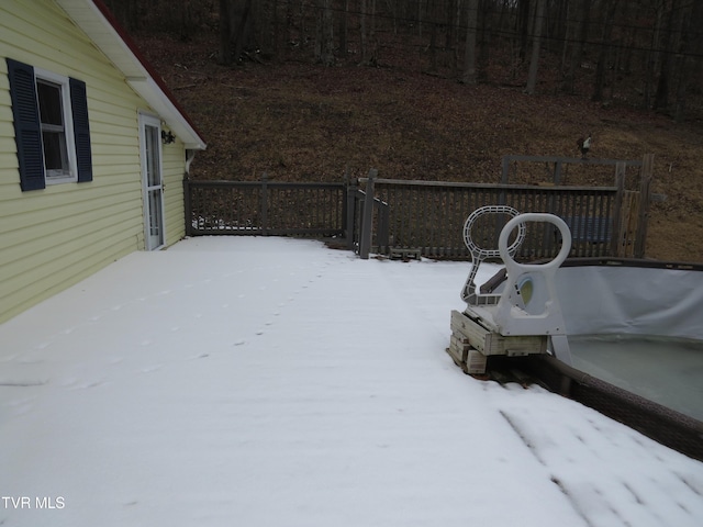 yard covered in snow featuring a wooden deck