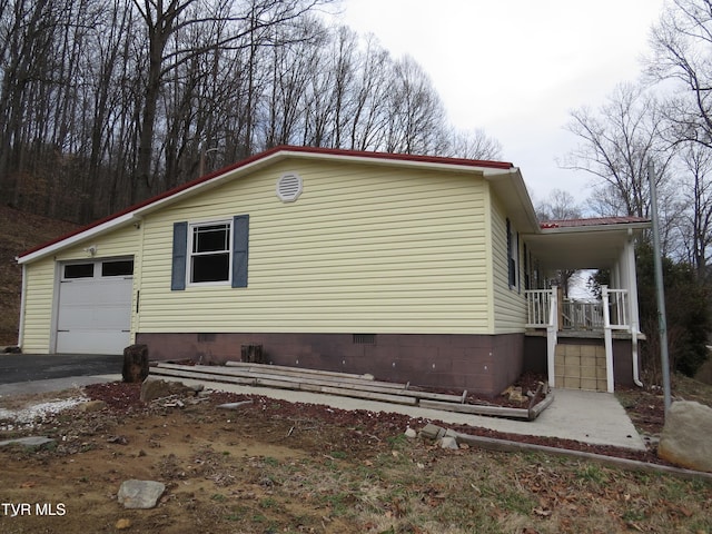 view of property exterior with crawl space, a porch, and metal roof