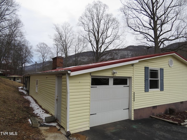 garage with aphalt driveway