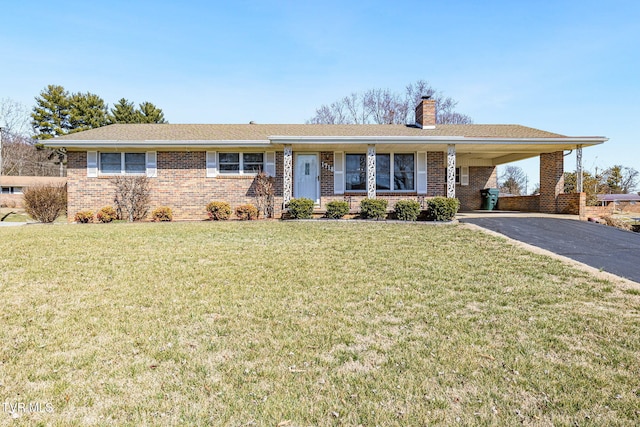 single story home with a carport, aphalt driveway, a front lawn, and a chimney