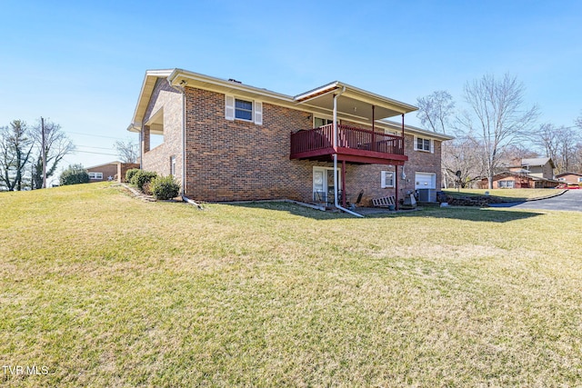 rear view of property featuring brick siding and a lawn
