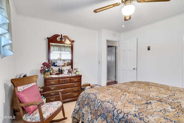 bedroom with a textured ceiling, a ceiling fan, and carpet flooring