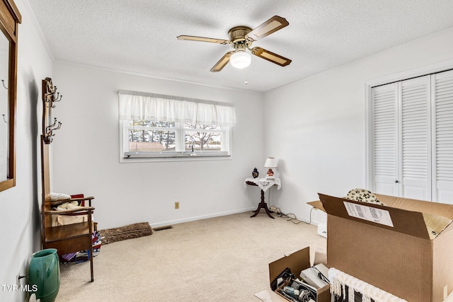misc room with ceiling fan, a textured ceiling, visible vents, and carpet flooring