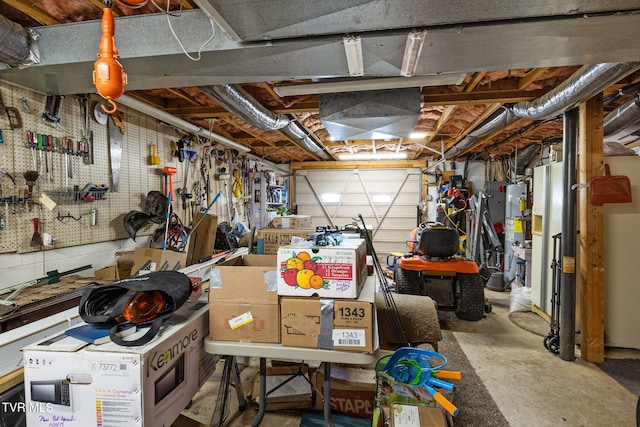 garage featuring gas water heater and a workshop area