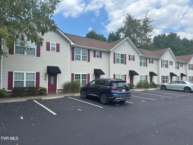 exterior space with uncovered parking and a residential view