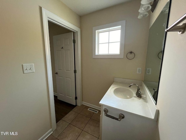 bathroom featuring baseboards, visible vents, vanity, and tile patterned floors