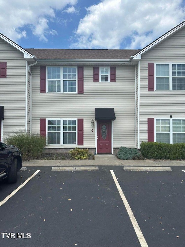 view of property featuring uncovered parking