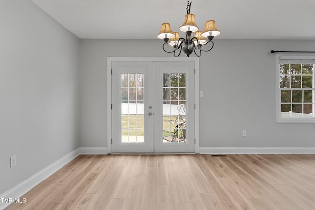 doorway to outside with light wood finished floors, french doors, baseboards, and a wealth of natural light