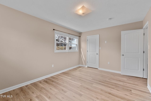 unfurnished bedroom featuring baseboards and light wood finished floors