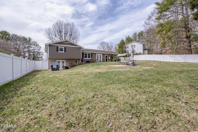 view of yard featuring french doors and a fenced backyard