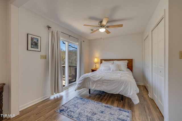 bedroom featuring access to exterior, a ceiling fan, baseboards, and wood finished floors