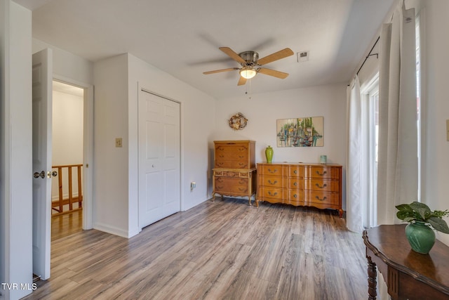 sitting room featuring visible vents, ceiling fan, and wood finished floors