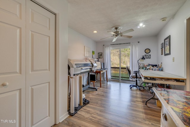 office with recessed lighting, ceiling fan, a textured ceiling, and wood finished floors