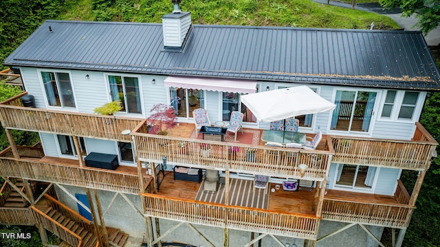 465 Big Oak Dr, Butler, TN 37640 - back of property featuring a chimney, metal roof, a wooden deck, and outdoor dining area