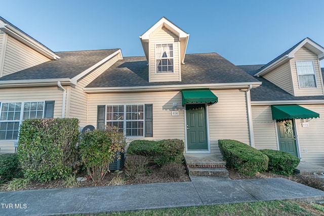 exterior space featuring roof with shingles