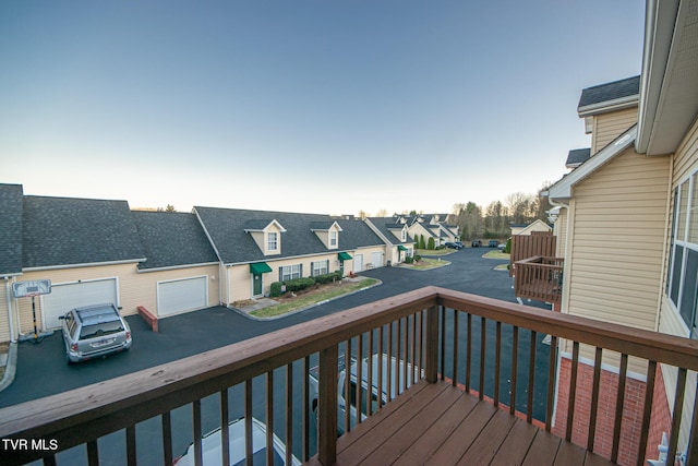 wooden deck with a garage and a residential view