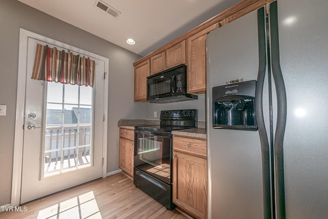 408 Stratford Ct Unit 408, Gray, TN 37615 - kitchen with light wood-type flooring, visible vents, black appliances, brown cabinets, and baseboards
