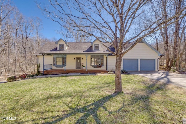 view of front facade with covered porch, driveway, an attached garage, and a front yard