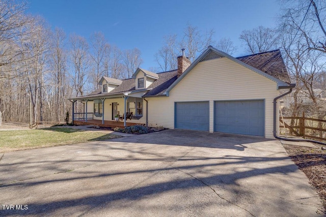 cape cod house featuring covered porch, driveway, a chimney, and an attached garage