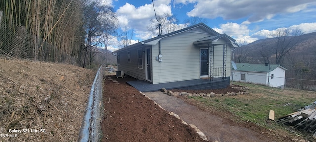 exterior space with central AC and fence