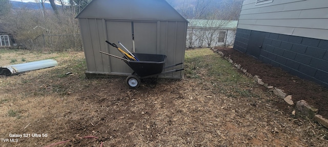 view of shed featuring fence