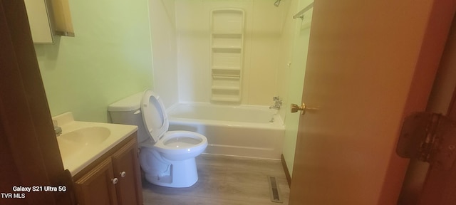 bathroom featuring washtub / shower combination, visible vents, vanity, and toilet