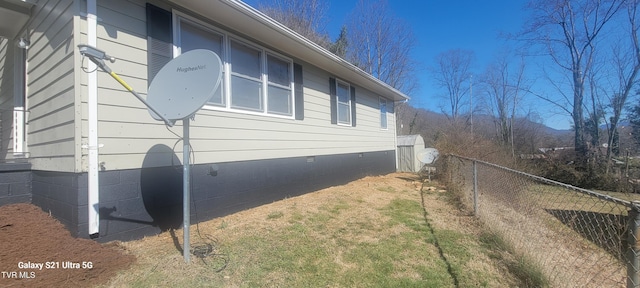 view of home's exterior featuring crawl space and fence