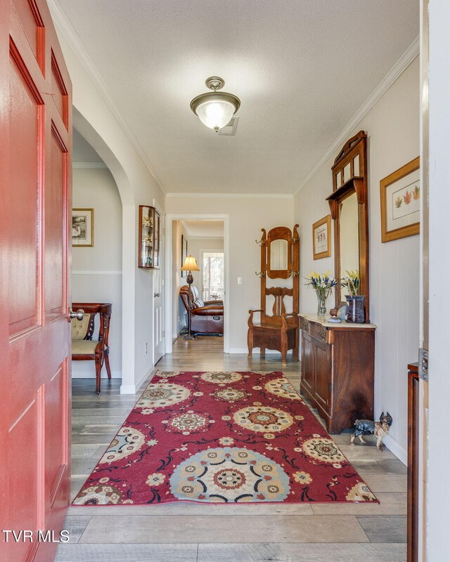1545 Old State Route 34, Telford, TN 37690 - foyer featuring wood finished floors, arched walkways, ornamental molding, and a textured ceiling
