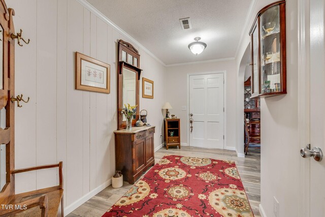 1545 Old State Route 34, Telford, TN 37690 - entrance foyer featuring ornamental molding, baseboards, a textured ceiling, light wood finished floors, and visible vents
