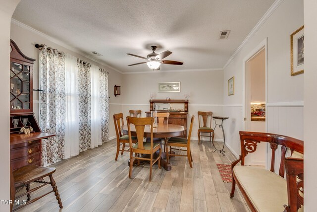 1545 Old State Route 34, Telford, TN 37690 - dining space featuring crown molding, a textured ceiling, light wood finished floors, visible vents, and a ceiling fan