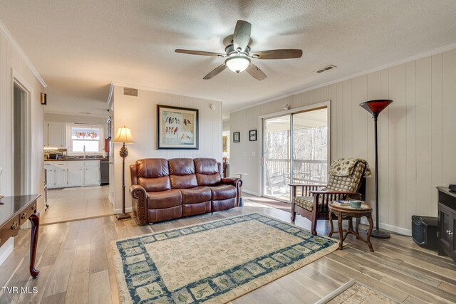 1545 Old State Route 34, Telford, TN 37690 - living area featuring a ceiling fan, ornamental molding, light wood finished floors, and visible vents