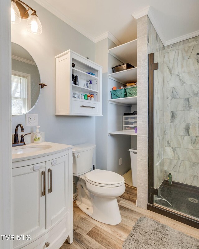 1545 Old State Route 34, Telford, TN 37690 - full bathroom featuring vanity, crown molding, toilet, a shower stall, and wood finished floors