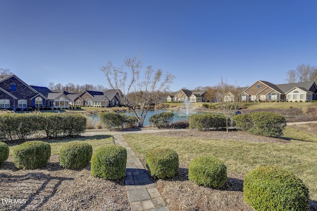 view of yard featuring a water view and a residential view