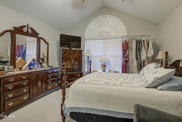 bedroom with lofted ceiling, ceiling fan, and light colored carpet