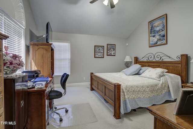 bedroom featuring lofted ceiling, multiple windows, a ceiling fan, and light colored carpet